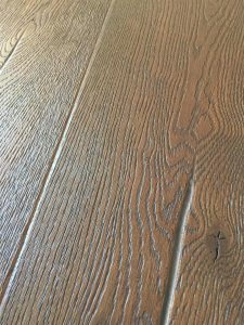 Dark wood oak flooring, deeply brushed and textured to create a beautiful antiqued floor.